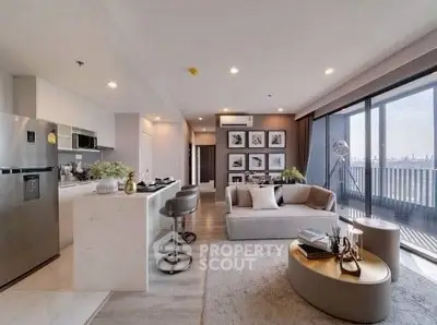 Modern open-layout living room and kitchen with stylish decor and city view balcony.