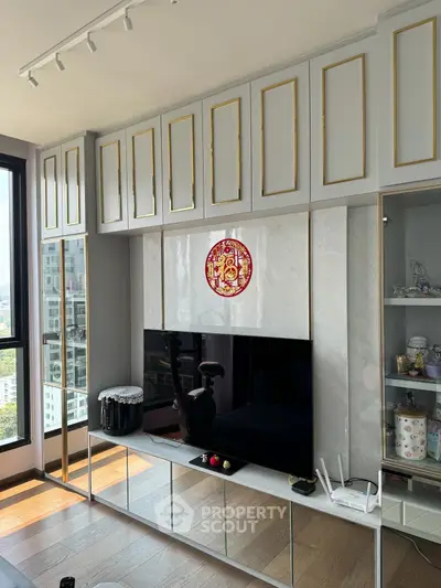 Luxurious living room with elegant cabinetry and modern decor in a high-rise apartment.