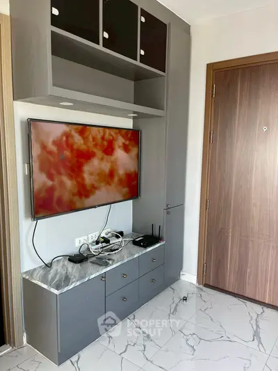 Modern living room with sleek TV unit and marble flooring