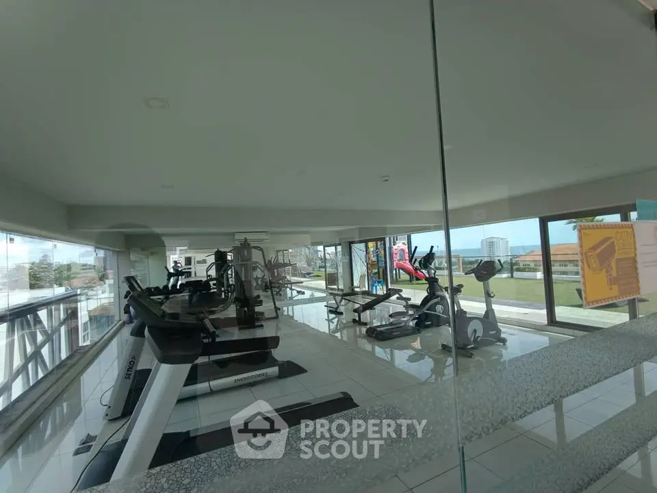 Spacious gym with modern equipment and panoramic city views