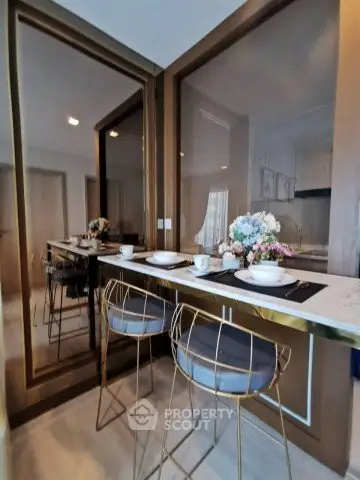 Stylish modern kitchen with elegant dining setup and mirrored accents