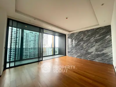 Spacious modern living room with floor-to-ceiling windows and city view