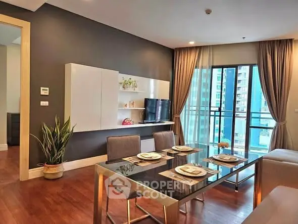Modern living room with dining area and balcony view in a stylish apartment.