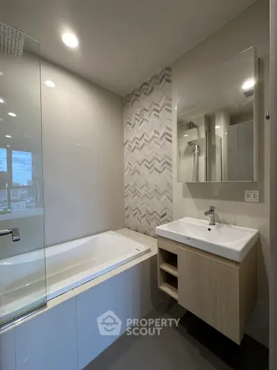 Modern bathroom with bathtub and stylish tile design in a contemporary apartment.