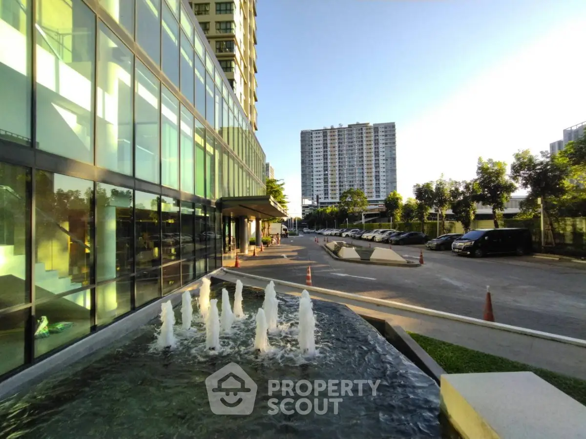 Modern building exterior with water fountain and urban view