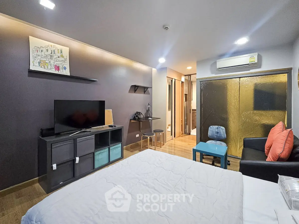 Modern studio apartment with cozy living area and stylish decor