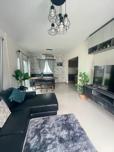 Stylish modern living room with sleek black furniture and elegant lighting