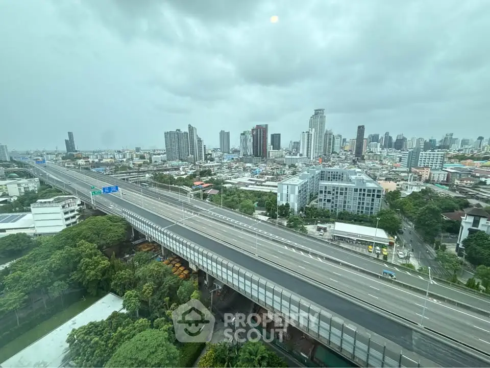 Stunning cityscape view from high-rise building overlooking highway and skyline.