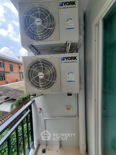 Modern balcony with air conditioning units and urban view