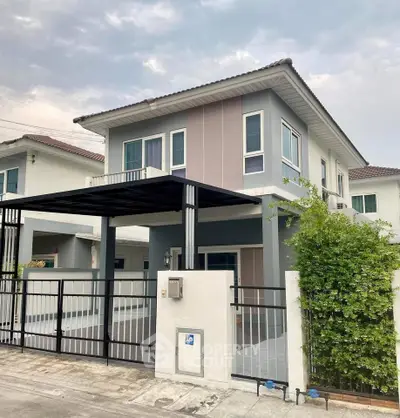 Modern two-story house with sleek design and spacious driveway in suburban neighborhood.