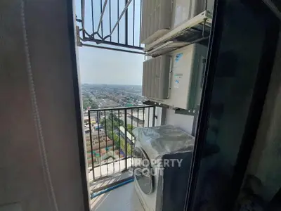 High-rise balcony with city view and laundry appliances, perfect for urban living.