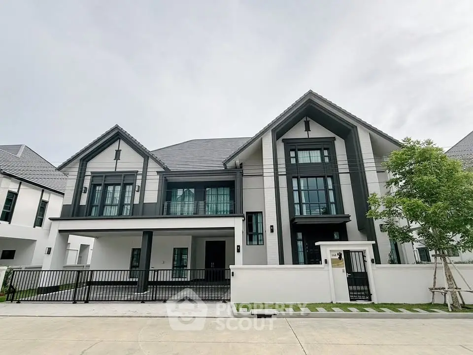 Stunning modern two-story house with sleek design and spacious driveway in a serene neighborhood.
