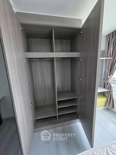 Spacious modern wardrobe with open doors in a bright bedroom setting