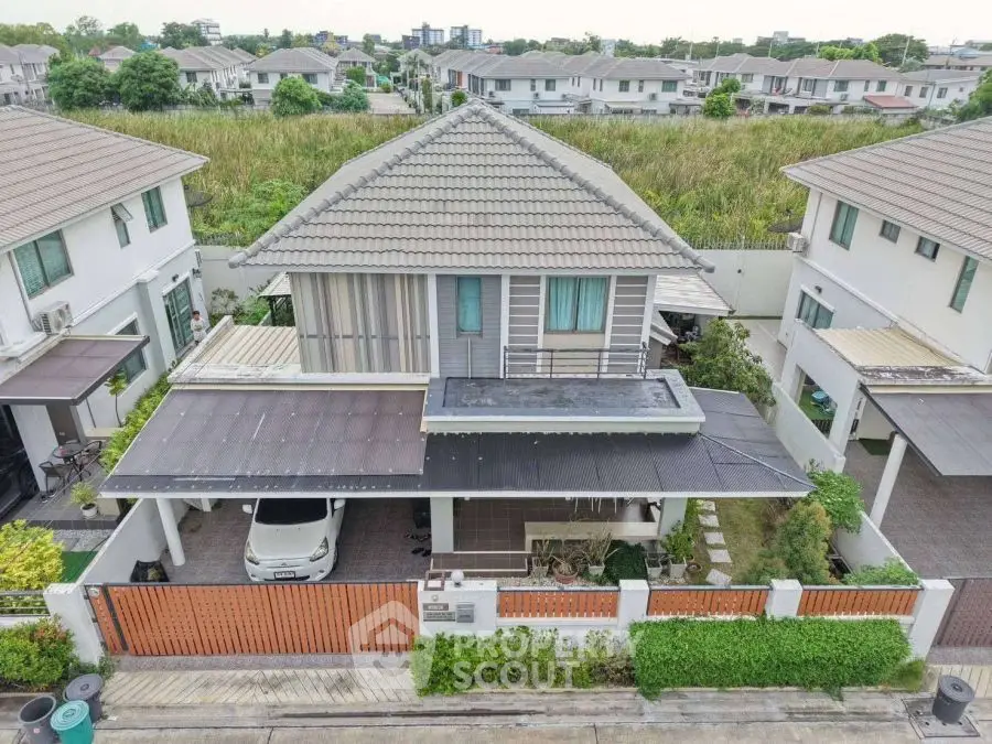Charming two-story house with modern design and spacious driveway in a serene neighborhood.