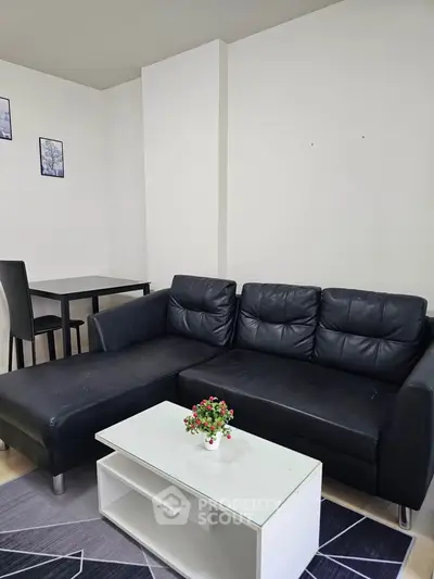 Modern living room with black leather sofa and minimalist decor