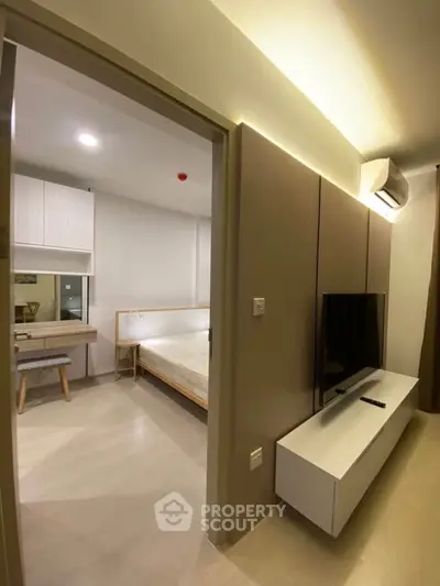 Modern apartment interior with sleek design featuring a cozy bedroom and stylish living area.