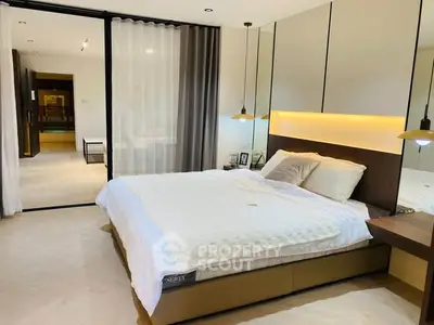 Luxurious bedroom with modern design and ambient lighting in a stylish apartment.