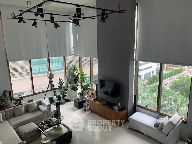 Luxurious modern living room with high ceilings and large windows offering stunning city views.