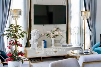 Luxurious living room with elegant decor, marble accents, and modern furnishings.