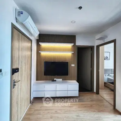 Modern apartment interior with stylish TV unit and wooden flooring