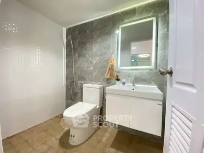 Modern bathroom with sleek design and elegant fixtures in a stylish real estate property.