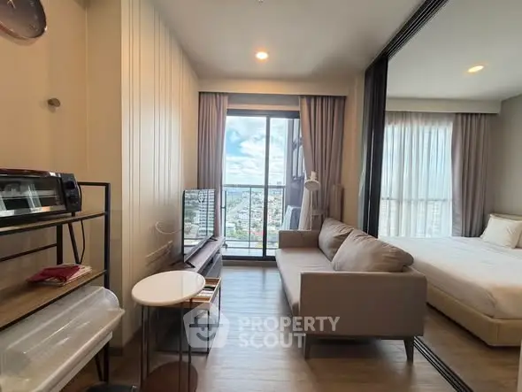 Modern studio apartment with city view, featuring cozy living area and bedroom, ideal for urban living.