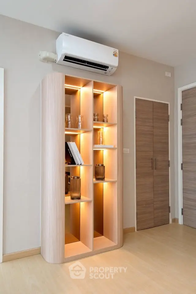 Modern interior with stylish wooden shelving and air conditioning unit, perfect for contemporary living spaces.