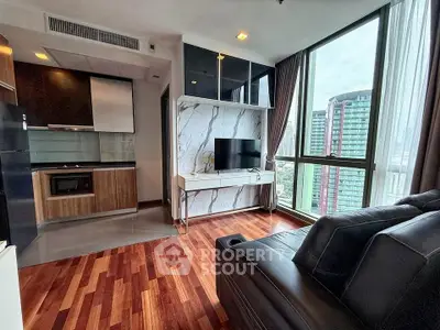 Modern living room with city view, featuring sleek kitchen and stylish decor.