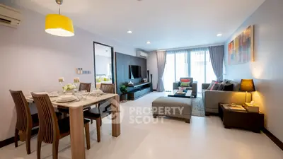 Spacious modern living room with dining area, stylish decor, and ample natural light.