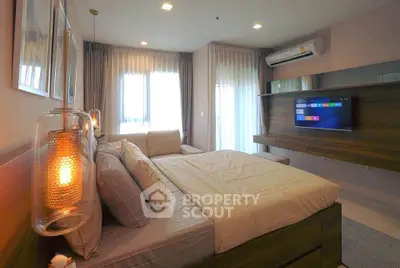 Luxurious bedroom with modern decor, ambient lighting, and wall-mounted TV in a stylish apartment.