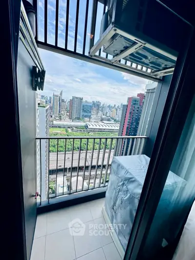 Stunning city view from a high-rise balcony with modern design and ample space.