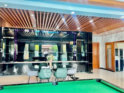 Luxurious modern living room with pool table and elegant dining area