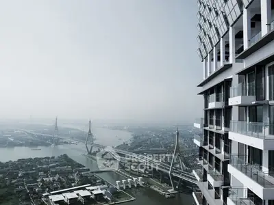 Stunning high-rise building with panoramic river and bridge views, perfect for luxury urban living.