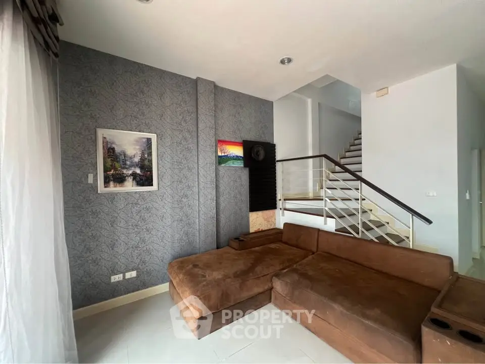 Modern living room with stylish decor and staircase