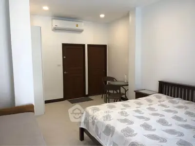 Cozy bedroom with modern air conditioning and stylish furniture