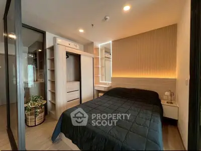 Modern bedroom with stylish lighting and built-in storage in a contemporary apartment.