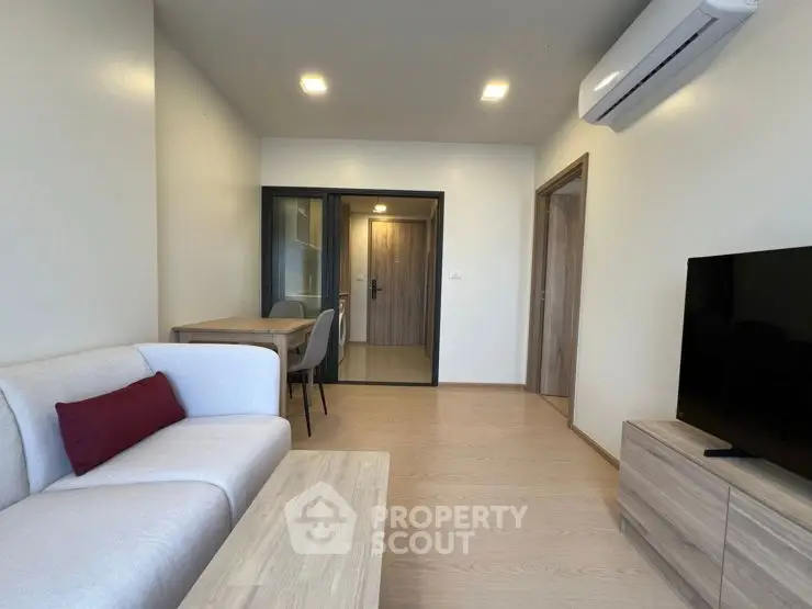 Modern living room with cozy sofa and dining area in stylish apartment