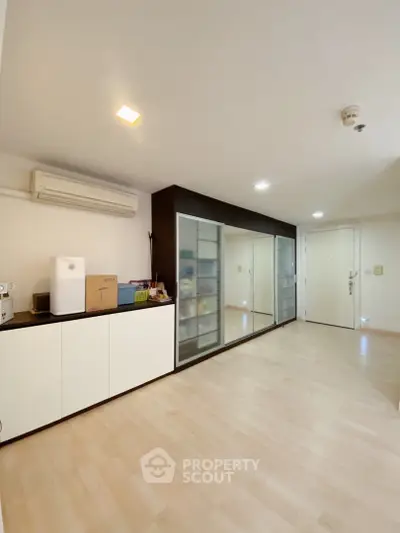 Spacious modern living room with sleek storage and air conditioning