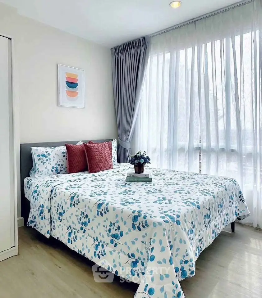 Bright and cozy bedroom with large windows and modern decor, perfect for relaxation.