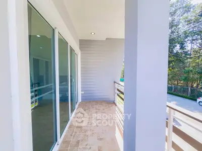 Spacious balcony with sliding glass doors and scenic view