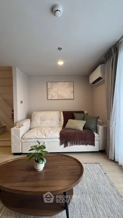 Cozy living room with stylish decor and natural light, featuring a comfortable sofa and modern coffee table.