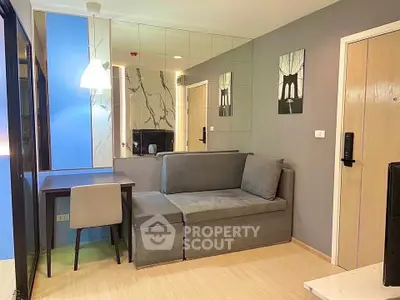 Modern living room with stylish gray sofa and chic decor in a cozy apartment.