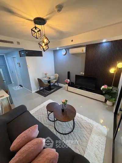 Modern living room with stylish lighting and cozy seating area, perfect for relaxation and entertainment.
