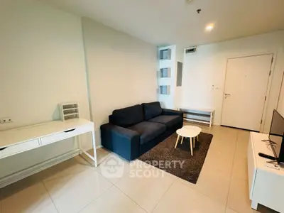 Modern living room with sleek furniture and neutral tones, perfect for relaxation and entertainment.