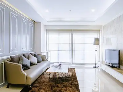 Elegant living room with modern decor, plush sofa, and large windows for natural light.