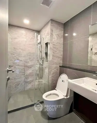 Modern bathroom with glass shower and sleek fixtures