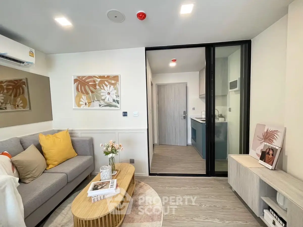 Modern living room with stylish decor and open kitchen layout in a cozy apartment.