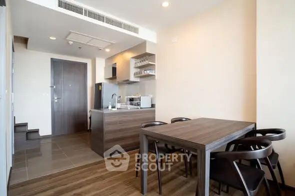 Modern kitchen with dining area and wooden furniture in a stylish apartment