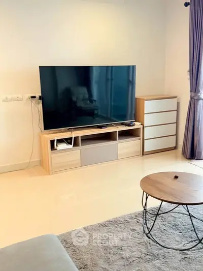 Modern living room with sleek TV setup and stylish furniture