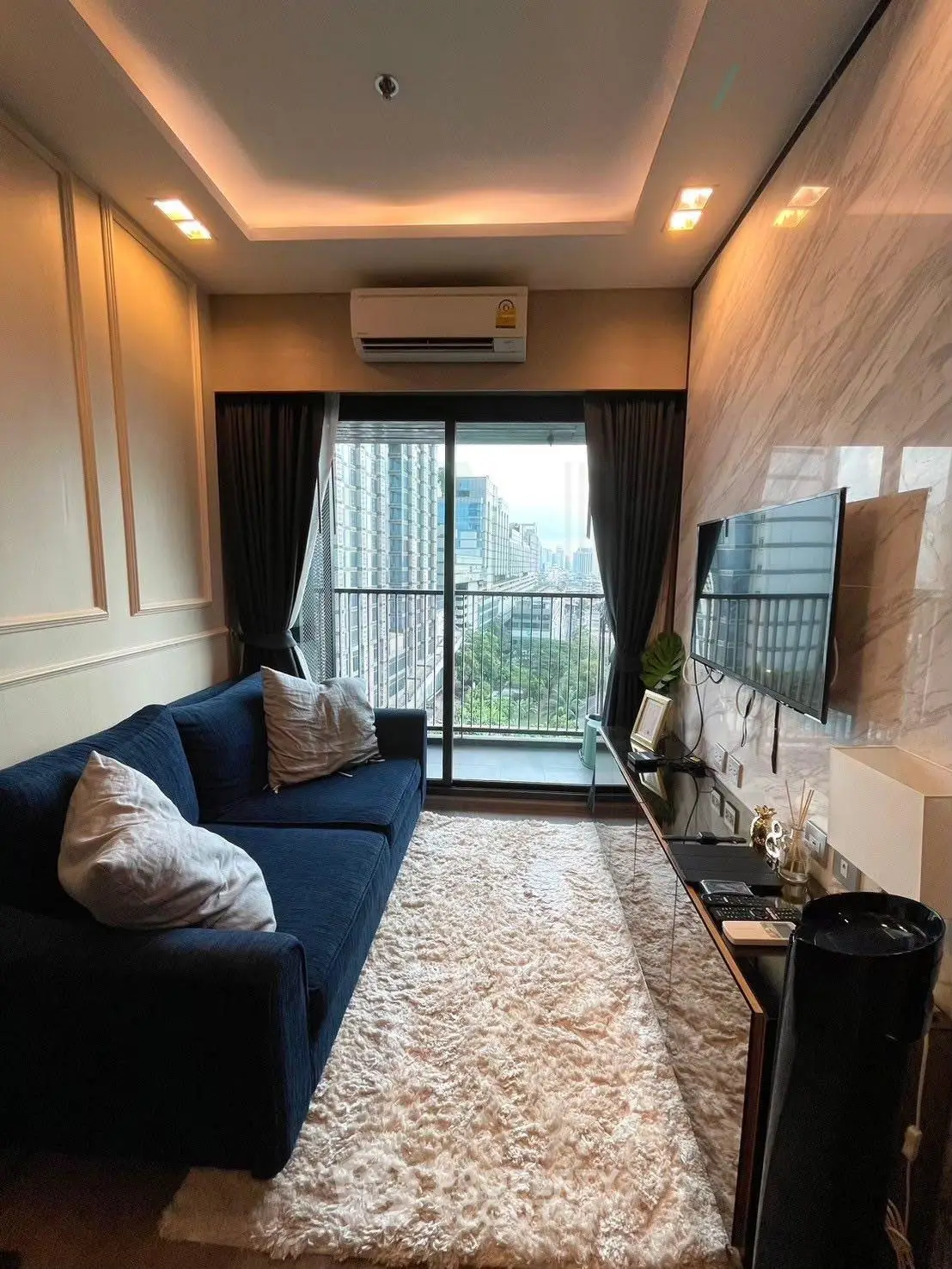Stylish living room with city view, modern decor, and cozy seating area.